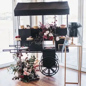Pernikahan logam manis permen layar troli hitam bunga besi pajangan keranjang dengan roda makanan penutup permen bar troli untuk pesta untuk dijual