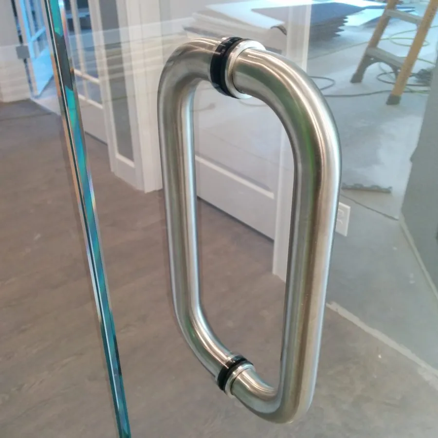 Close up of glass doors in to office room with stainless steel door handles