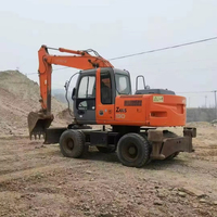 Excavatrice sur pneus Hitachi ZX130 d'occasion, 13 tonnes, très demandée, d'origine japonaise, certifiée CE, avec attache rapide et brise-roche, Daewoo