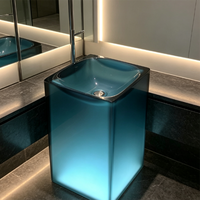 Lavabo colonne transparent bleu avec éclairage LED et système de vidange, style hôtel haut de gamme