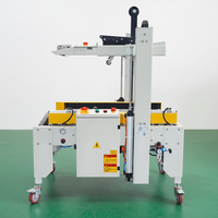 Machine de scellage de bande de boîte de carton aléatoire entièrement automatique de dimension non uniforme à vendre