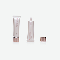 Tubo exprimible de PE color champán mate con impresión de logotipo personalizado y tapa electrochapada en oro rosa para crema tonificante UV.