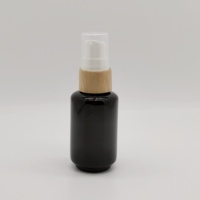 Emballage cosmétique de bouteille de pompe en verre de haute qualité 30ml bouteille ronde de fond en verre noir brillant bouteille d'huile avec pompe à lotion
