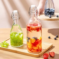 Vente à chaud Big Belly 350ml 500ml 750ml 1000ml Bouteille d'eau ronde en verre transparent Bouteilles de boisson en verre à dessus pivotant avec bouchons
