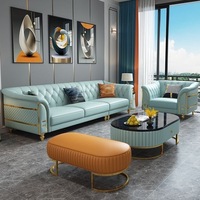 Ensemble de canapés capitonnés en cuir véritable avec ottoman, fauteuil et pieds en métal doré, matelassé, luxe bleu-orange pour salon et villa