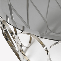 Table basse Aquarius avec plateau en verre fumé et base en acier inoxydable poli, design moderne élégant pour salon