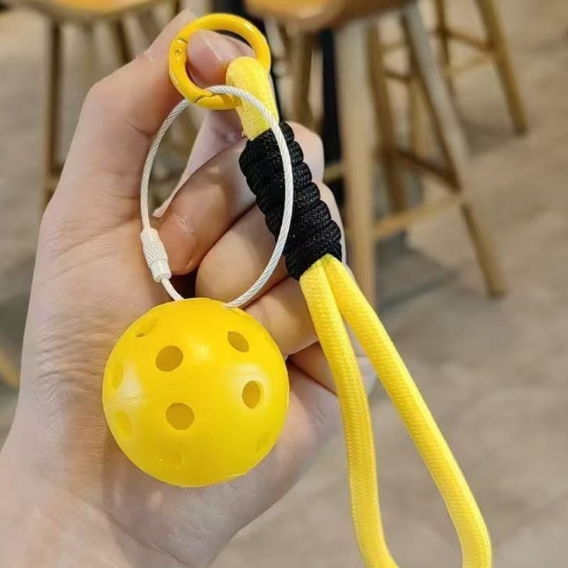 Development of durable and practical pickleball accessories, including mini pickleball keychains.