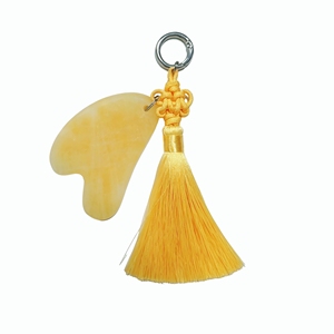 Outils de massage portables, planche de guasha en jade jaune avec porte-clés à pompon jaune pour massage facial - Product Image 1