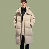Veste longue matelassée pour homme en duvet de canard blanc 90 %, personnalisable OEM/ODM, avec capuche, coupe oversize, poches à rabat avec cordon de serrage, idéale pour l'hiver et les loisirs.
