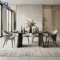 Ensemble de table à manger de luxe avec 6 chaises, plateau en marbre noir, base en acier foncé en forme de V, fauteuils en tissu PU, style Japandi, villa, vente en gros, usine OEM