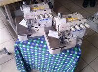 Machine à coudre industrielle JUKIS 6714 à quatre fils d'occasion en bon état