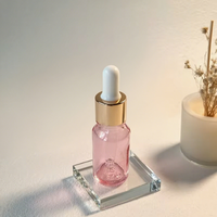 Haute qualité 10ml rose cosmétique compte-gouttes bouteilles en verre forme de cylindre personnalisé huile essentielle soins de la peau sérum conteneurs bouchon à vis