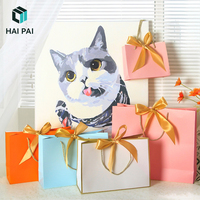 Sacs cadeaux de luxe en papier écologique avec logo personnalisé et poignées en ruban pour l'emballage de vêtements et de bijoux de détail