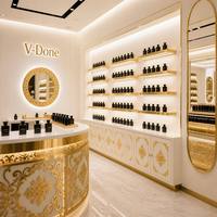 Vitrine de présentation de parfums sur mesure avec cadre doré, éclairage LED, comptoir îlot rond pour boutique de cosmétiques et de parfums