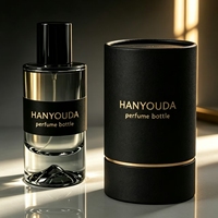Flacon atomiseur de parfum cylindrique haut de gamme gris fumé à base épaisse, avec fond créatif en forme de montagne de glace et capuchon noir brillant, en verre personnalisé
