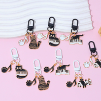 Porte-clés en alliage de zinc avec motif de petit chat noir musical de dessin animé et notes de piano, accessoire de sac mignon et original pour hommes et femmes