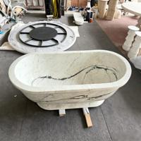 Baignoire autoportante ovale en marbre blanc avec rebord large et base sculpturale pour villas et hôtels