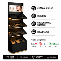 Support d'affichage cosmétique noir personnalisé par le fabricant avec écran LCD pour les magasins de détail de produits de beauté