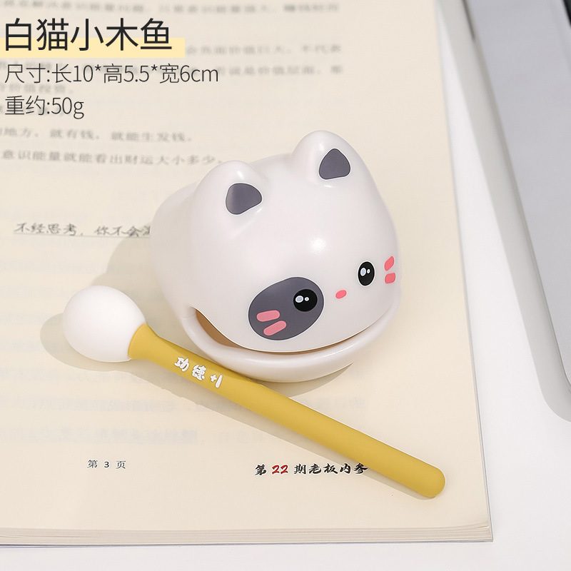 White cat-small wooden fish