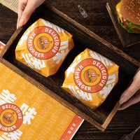 Papier d'emballage pour hamburgers écologique et résistant à la graisse, personnalisable avec logo, idéal pour les boulangeries, restaurants et emballages à emporter pour la restauration rapide.