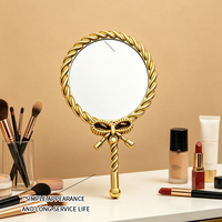 Miroir à main vintage en plastique avec nœud torsadé, cadre en cuir PU plaqué argent, cosmétique portable, style rétro européen, pour maquillage
