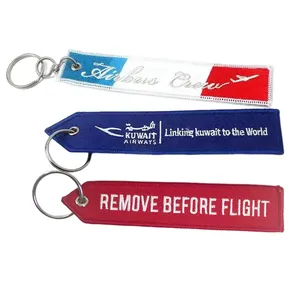 저렴한 선물 열쇠 고리 태그 도매 사용자 정의 로고 자수 직물 비행기 열쇠 고리 비행 전에