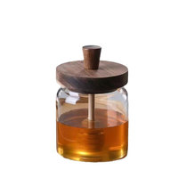 Más vendidos 500ml 16oz Tapa de madera transparente Jarabe Dispensador de miel Contenedor de almacenamiento Tarro con cucharón de madera
