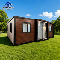 Maison conteneur extensible à grain de bois foncé, double aile, cadre noir, villa préfabriquée, entrepôt clé en main, maison de vacances moderne pour complexe hôtelier