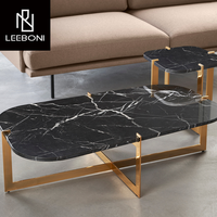 Meubles de salon de luxe sur mesure, cadre en métal doré en forme de croix, plateau rond en marbre noir, table basse