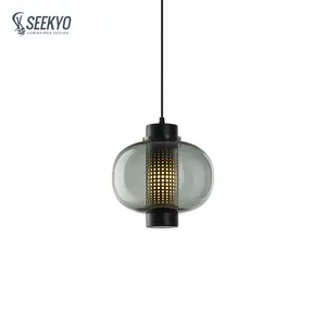Black or coppery glass restaurant pendant lights with metal carved round holes emit soft light