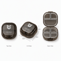 Boîte à pilules ovale en plastique PP noir translucide, 7 compartiments, suivi quotidien AM/PM, boîte à médicaments scellée, design moderne minimaliste, logo personnalisé
