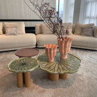 Table basse moderne en forme de fleur avec surface aspect marbre vert pâle, table sculpturale de luxe avec pieds en bois pour salon
