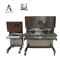 Machine automatique de remplissage bouchage de poche de bavoir aseptique liquide jus de vin rouge eau lait huile d'olive remplissage de sac dans la boîte