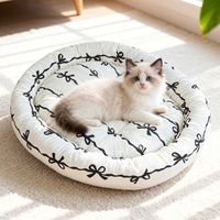 Lit pour chien et chat en peluche moderne, mignon et apaisant, en forme de beignet, avec tapis intégré