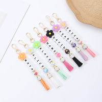 Nouveau Porte-clés en silicone style japonais-coréen transfrontalier, motif fleur, avec perles lettres DIY et pompon, ornement pendentif pour voiture et sac, modèle Chine