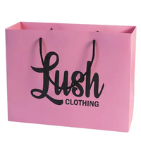 Conception personnalisée écologique de luxe en noir et blanc pour la vente au détail de sacs en papier épais impression laminée pour le shopping emballage cadeau pour vêtements