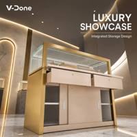 Vitrine d'îlot à bijoux en or brossé avec tiroirs de rangement, comptoir de présentation de bijoux en verre trempé à LED pour boutique de luxe
