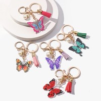 Vente en gros porte-clés personnalisé imprimé de luxe fermoir mousqueton perle papillon pendentif style dessin animé sac voiture acrylique porte-clés gland