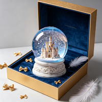 Globe à neige chic en forme de château flottant avec flocons de neige, base en marbre, boule de verre pour anniversaire et décoration de maison de luxe
