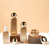 Nouvel ensemble de flacons de soin en verre dégradé orange 40/100/120 ml avec pompe à pression pour emballage d'eau en crème, d'essence, de lotion et de sérum