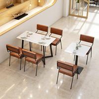 Moderne minimalistische commerciële cafétafel met metalen poten en comfortabele PU lederen stoelenset voor koffieshop en fastfood