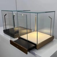 Vitrine de comptoir en verre trempé avec base en acier inoxydable et éclairage LED pour les bijouteries