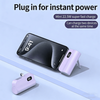 Mini Power Bank 5000 mAh avec affichage numérique, support de téléphone 3-en-1, double tête et câble intégré, format capsule