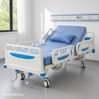 Lit médical manuel 2 fonctions avec tête de lit ABS, rail rabattable en polypropylène, descente à fermeture douce, capacité 170 kg, verrouillage central, roulettes
