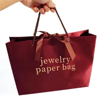 Sacs d'emballage d'achat en papier avec poignées pour vêtements Sac cadeau de luxe personnalisé pour vêtements