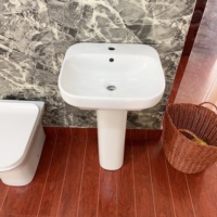 Lavabo rond en céramique blanche au design moderne et élégant avec piédestal pour appartements, facile à nettoyer