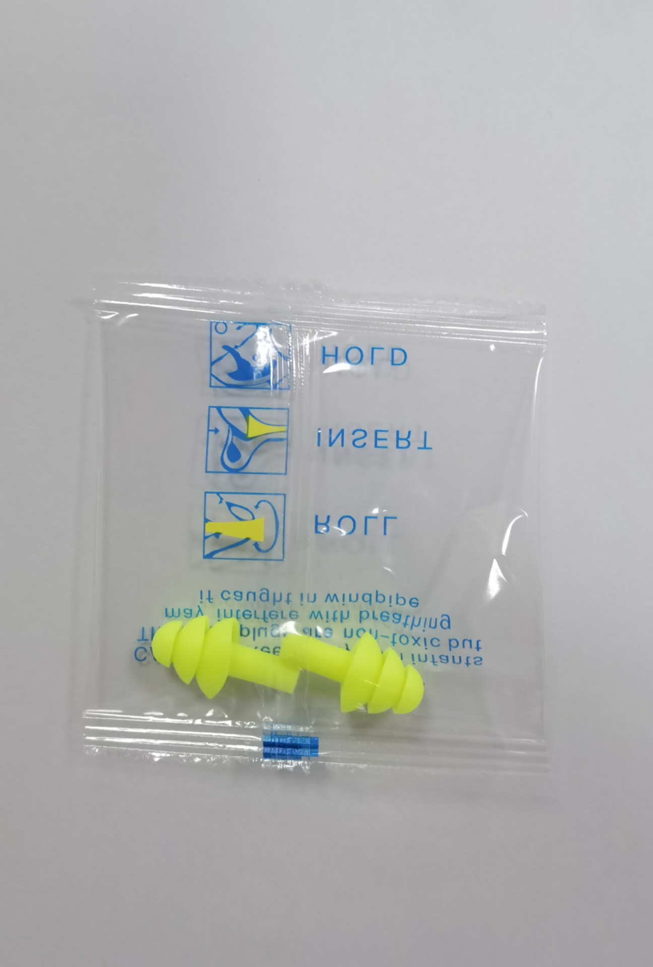 Fluorescent color - A pair of earplugs in a bag