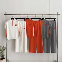 Ensemble tricoté style européen d'été : Sweat-shirt à col montant zippé brodé jacquard à manches courtes et pantalon décontracté à jambes larges