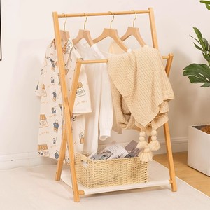 Simple and multifunctional <b>clothes</b> <b>rack</b> with cross-shaped design, perfect for bedside, bedroom, or children's use. - Product Image 1