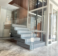 Escalier en marbre empilé lumineux avec garde-corps en verre et éclairage d'escalier chaleureux